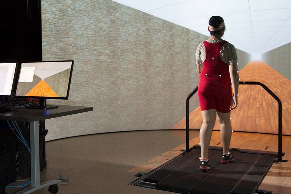 Individual being tested while walking on a treadmill