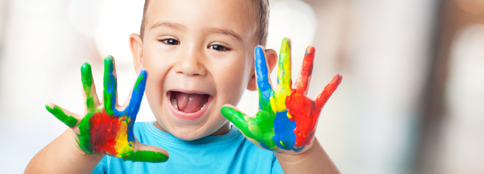 Excited child painting with their hands